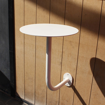 A wall mounted cafe table creates a contemporary look in cafés and offices. Its clean lines make it a perfect choice for modern interiors.
