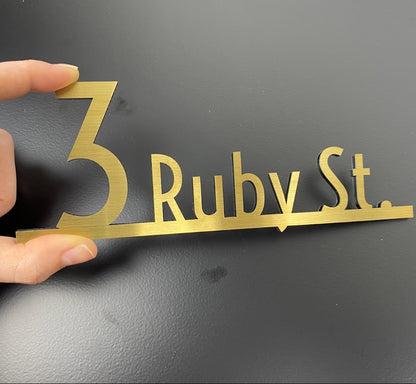 Guide visitors efficiently with the Wayfinding numbers and name sign, a sleek and modern directional sign. The customizable font and height allow for a perfect fit with your space’s aesthetic while ensuring clear directional guidance. The easy-to-use adhesive backing makes installation quick and secure. Built with durable, weather-resistant materials, it’s ideal for both indoor and outdoor use. This sign offers both practicality and elegance, enhancing the navigational experience while adding a refined touc