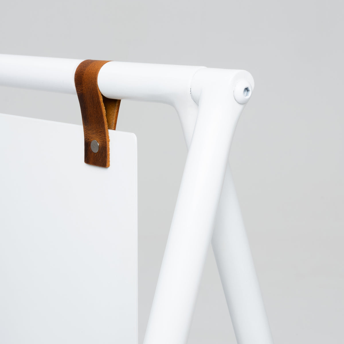 Close-up of leather panel strap and hinge on white A-frame sign