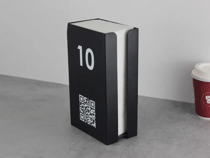 Our napkin dispensers are crafted from durable materials and designed for easy use. The inclusion of customizable table numbers and QR codes enhances both quality and convenience in your dining experience.